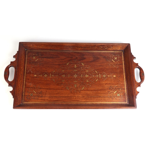 770 - A Middle Eastern brass inlaid hardwood two-handled tray, 64cms wide.