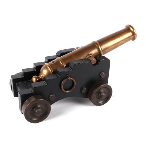 78 - A cast bronze signal cannon mounted on a hardwood carriage with brass wheels and fittings. Barrel le... 