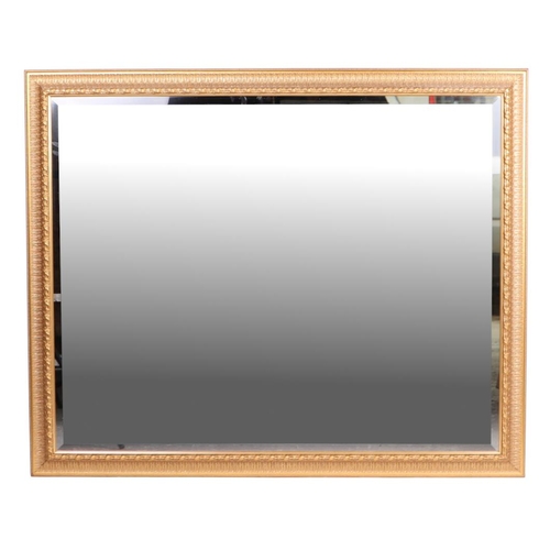 852 - A large modern bevel edged gilt framed mirror, overall 128cm by 104cm.