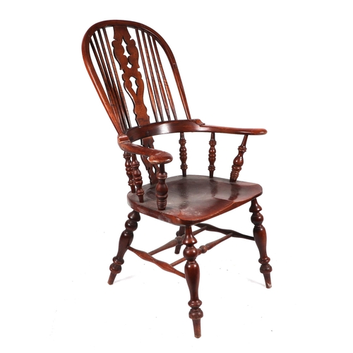 854 - A Windsor beech, oak and elm armchair with pierced back splat, solid seat and shaped legs joined by ... 