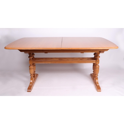 864 - A blonde Ercol Dorchester Elm extending dining table with three extra leaves,  100cm by 222cm.