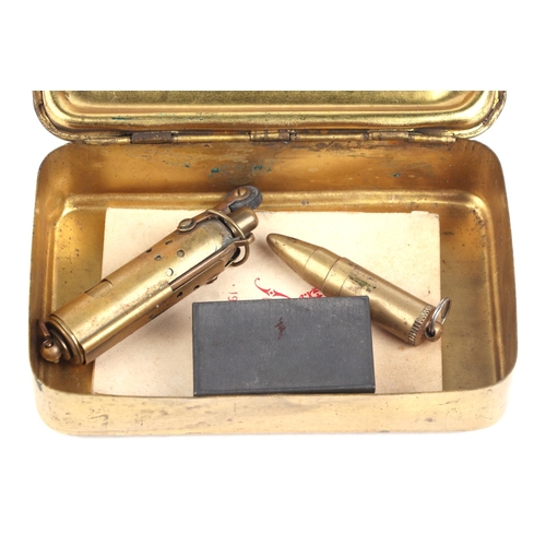 95 - A WWI 1914 Princess Mary Christmas tin containing Christmas card, two lighters and a razor.