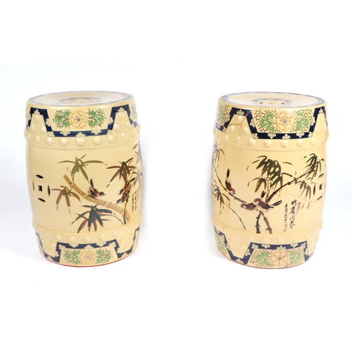 696 - A pair of Chinese barrel form ceramic window garden seats decorated with birds amongst bamboo and ca... 