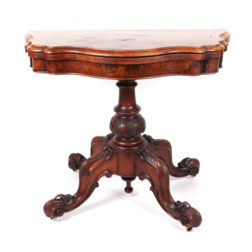 857 - A Victorian burr walnut card table on turned and carved column and quatrefoil base, 90cms wide.