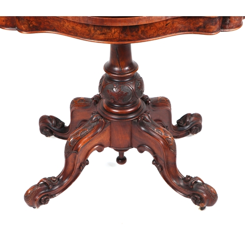 857 - A Victorian burr walnut card table on turned and carved column and quatrefoil base, 90cms wide.