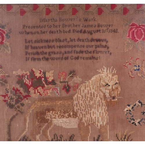 125 - A large framed needlework sampler with a central lion and verse within a meandering flowers by Marta... 