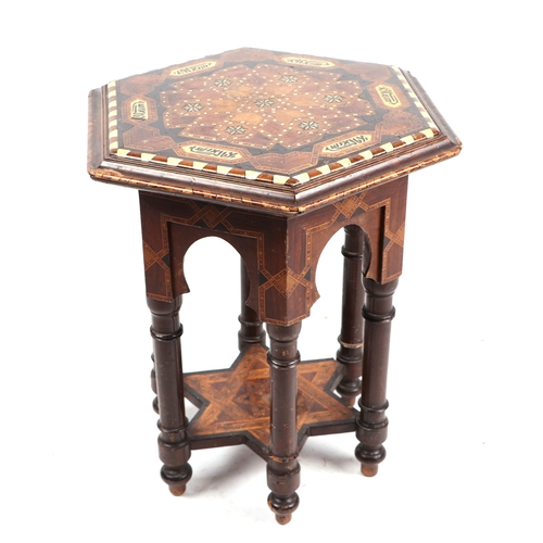 736 - An Islamic / Syrian hexagonal small occasional table with bone inlaid decoration, 42cms wide.