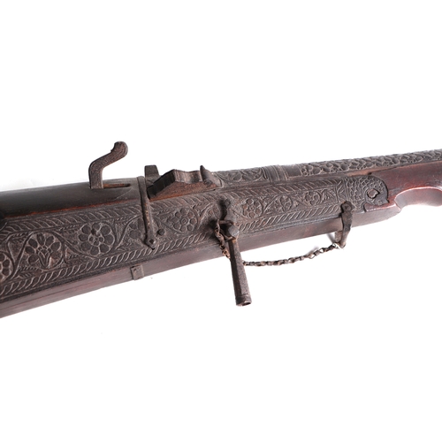 112 - An Indo-Persian Matchlock musket with ornate foliate scroll decoration, 153cms long.Condition Report... 