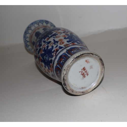 682 - A Chinese blue, red and white vase with six character red mark to the underside, 25cms high.