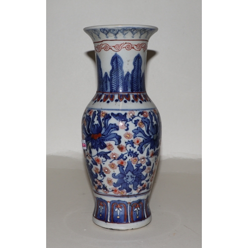 682 - A Chinese blue, red and white vase with six character red mark to the underside, 25cms high.