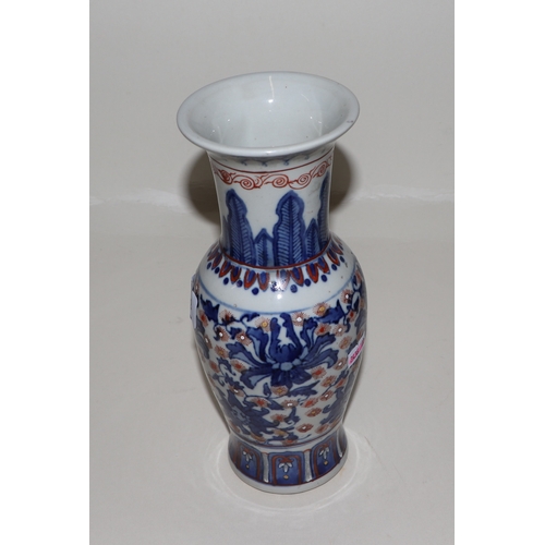 682 - A Chinese blue, red and white vase with six character red mark to the underside, 25cms high.