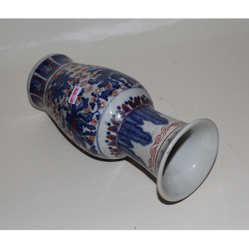 682 - A Chinese blue, red and white vase with six character red mark to the underside, 25cms high.