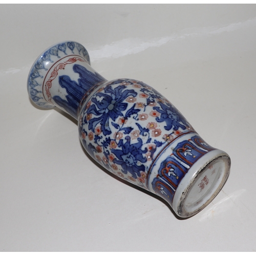 682 - A Chinese blue, red and white vase with six character red mark to the underside, 25cms high.