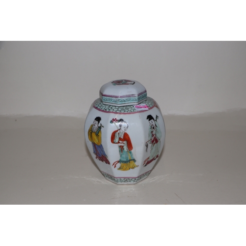 675 - A Chinese famille rose ginger jar and cover of octagonal form, decorated with figures, 15cms high.