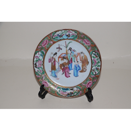 656 - A 19th century Canton Export famille rose plate decorated with figures within a landscape, 20cms dia... 