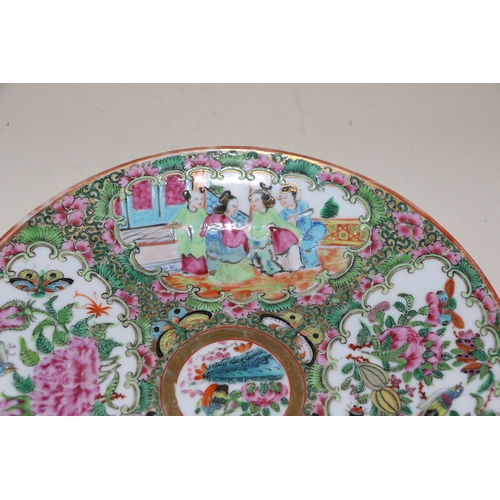 656 - A 19th century Canton Export famille rose plate decorated with figures within a landscape, 20cms dia... 