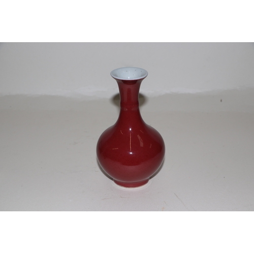 640 - A Chinese sang de boeuf baluster vase, 15cms high.