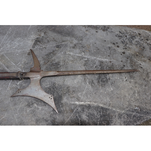 111 - A 16th century style continental Halberd on a chamfered oak shaft, 206cms high.