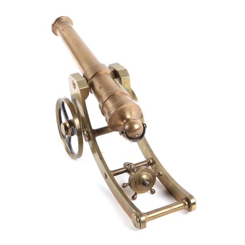 124 - A cast brass cannon on carriage, with 20cm long barrel.