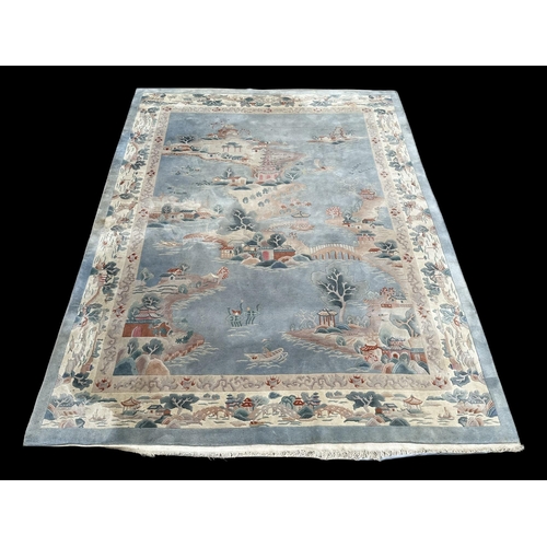 150 - A large Chinese carpet with floral motifs on a blue ground, within a scrolling border, 371 by 272cm.