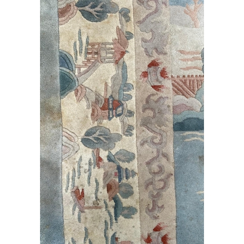 150 - A large Chinese carpet with floral motifs on a blue ground, within a scrolling border, 371 by 272cm.