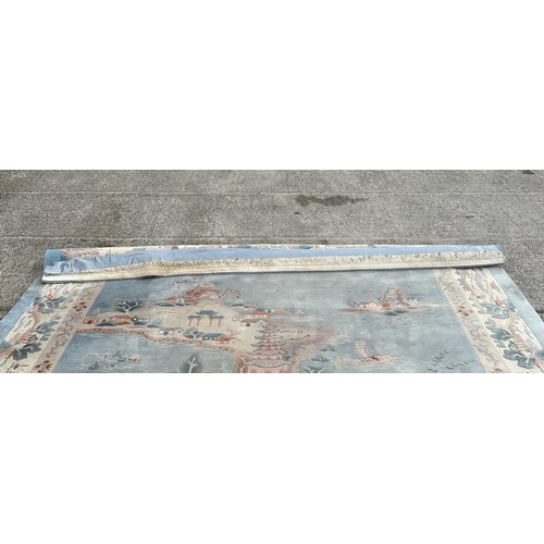 150 - A large Chinese carpet with floral motifs on a blue ground, within a scrolling border, 371 by 272cm.