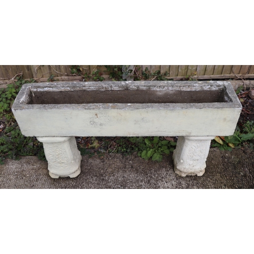 19 - A stone rectangular planter, on two square column supports, 107cm wide.