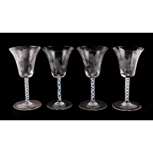 280 - A set of four etched wine glasses, with air twist stems, 18cm high (4)