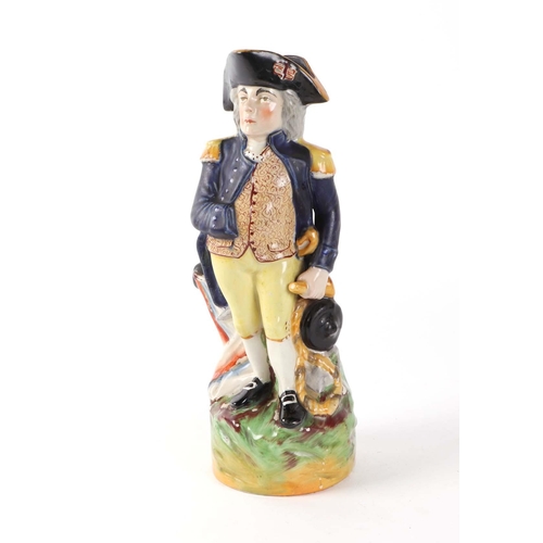 284 - A Staffordshire pottery figural water jug, depicting Lord Nelson, 29cm high.