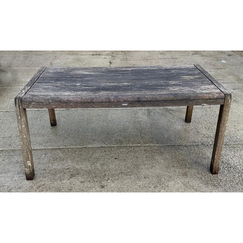 29 - A well weathered teak garden set consisting of a rectangular table, 169cm long; two benches and two ... 