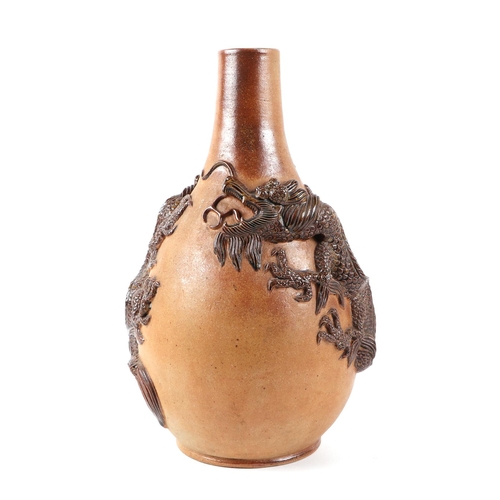 302 - A pottery bottle vase, having high relief dragon decoration, 35cm high.