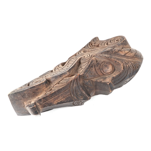 324 - A pair of oceanic hardwood carved corbels, depicting stylised faces, 47cm high.