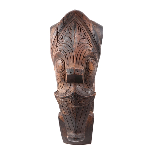 324 - A pair of oceanic hardwood carved corbels, depicting stylised faces, 47cm high.