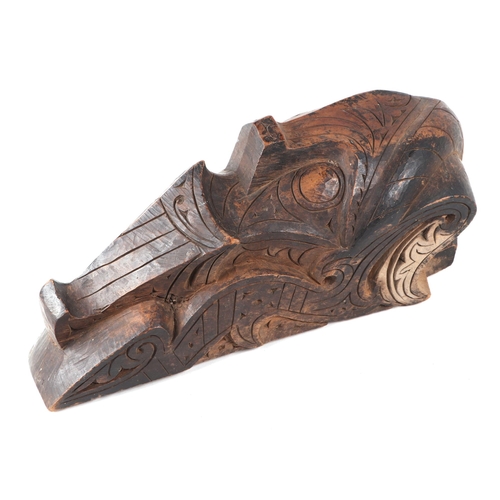 324 - A pair of oceanic hardwood carved corbels, depicting stylised faces, 47cm high.