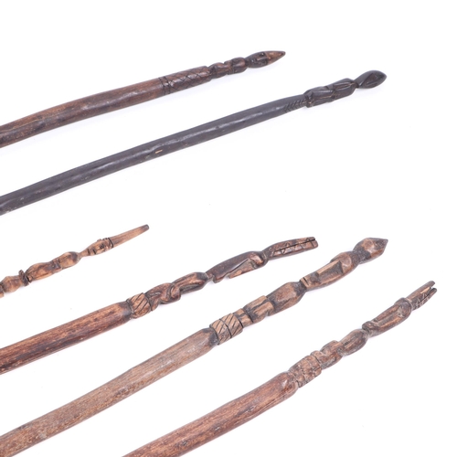 326 - A group of six African ceremonial dance wands, with figural terminals, largest 119cm long (6).