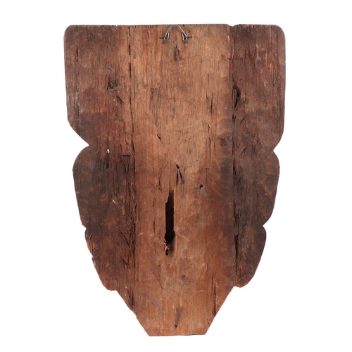 327 - An Indonesian Dayak stylised wall mask, 39 by 52cm.