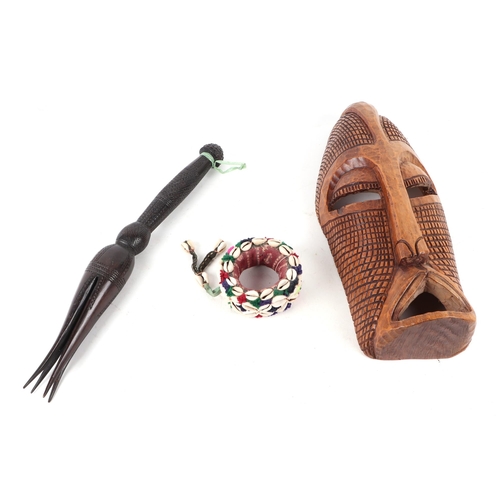 331 - A Fijian carved hardwood cannibal fork with four prongs, 46cm long; three African carved tribal mask... 