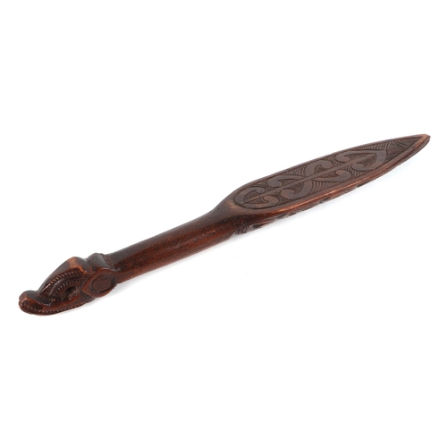 333 - A Maori carved wooden dance paddle, with Tiki inlaid decoration, 48cm long.