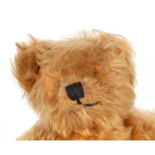 356 - A vintage plush teddy bear, 20cm high.