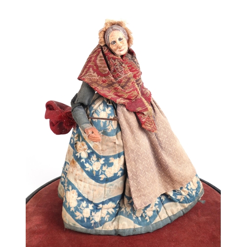 388 - A terracotta Pedlar Doll figure depicting an old lady, signed to the underside, on an ebonised and v... 