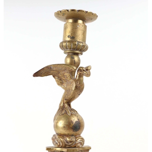 392 - A pair of French brass Empire style candlesticks with eagle perched on bull sconces, Corinthian colu... 