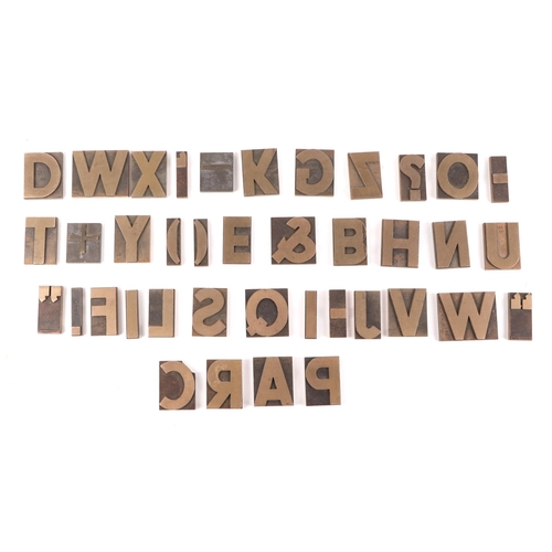 403 - A full alphabet of brass printing blocks.