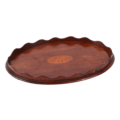 408 - An Edwardian oval inlaid mahogany card tray, with central shell motif, 30cm wide.