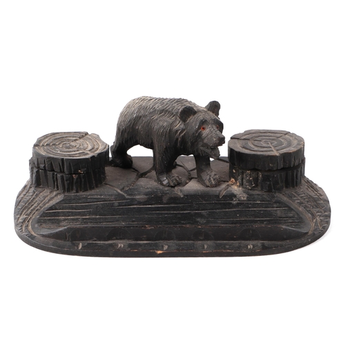 414 - A Black Forest carved wood pen and ink stand, having a bear flanked by two ink wells and pen dish, 2... 