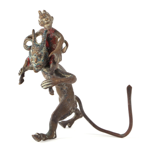 420 - A cold painted bronze group, depicting a small devil riding the shoulders of a larger devil, 7cm hig... 