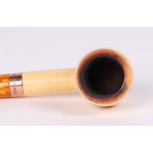 422 - A cased pipe, with amber type mouth piece and 9ct gold collar, 14cm long.