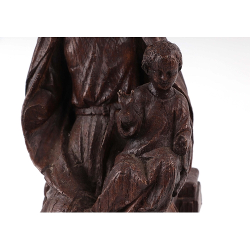 427 - An 18th century style faux oak figural group, depicting the Madonna and Child, 42cm high.