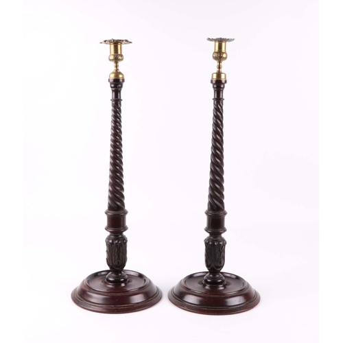 451 - A large pair of mahogany candle sticks, with brass sconces, 55cm high.