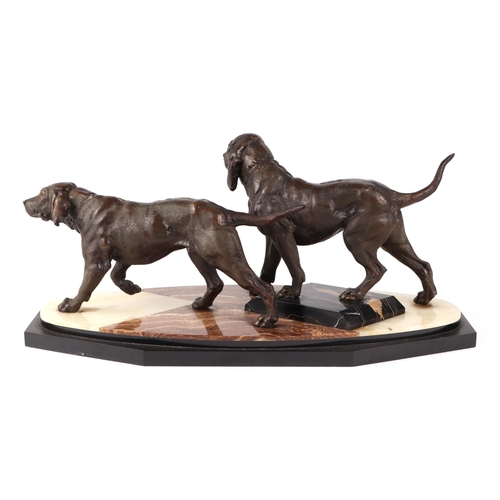 456 - A bronze group depicting a pair of hunting dogs, on a stepped onyx base, 50cm wide.