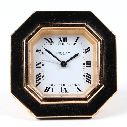 463 - A Cartier gilt metal and black enamel table alarm clock, the white dial with Roman numerals, number ... 